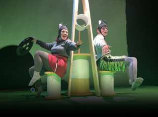 Two actors on stage dressed as mice.