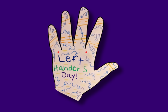 A paper left hand colorfully decorated and with the text "Left Handers Day!" 