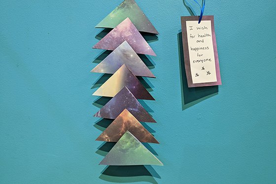Galaxy colored paper triangles attached in a column. 