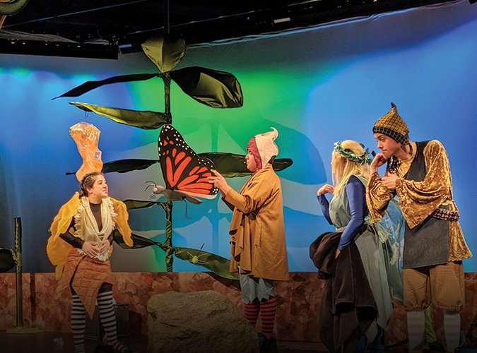 Photograph of the cast of My Butterfly on stage with a butterfly puppet.