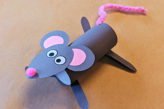 A gray rat made from construction paper, a pink pompom nose and pink pipe cleaner tail. 