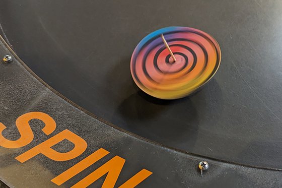 A rainbow spinning top in motion. 